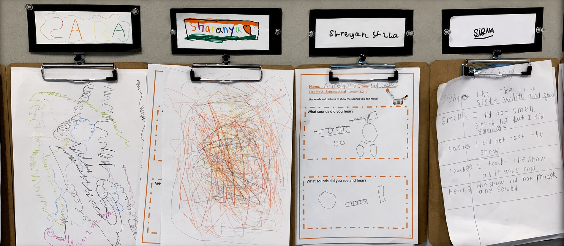 Students choosing what they are proud of to display on the wall